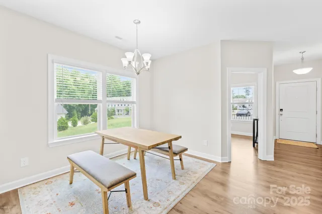 a view of a dining room with furniture wooden floor and chandelier