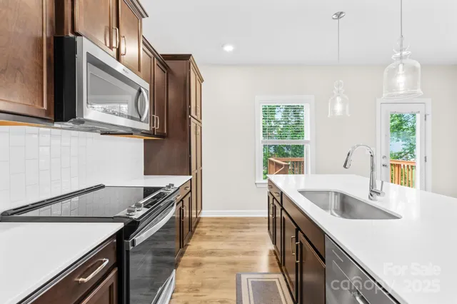 a kitchen that has a sink and a stove