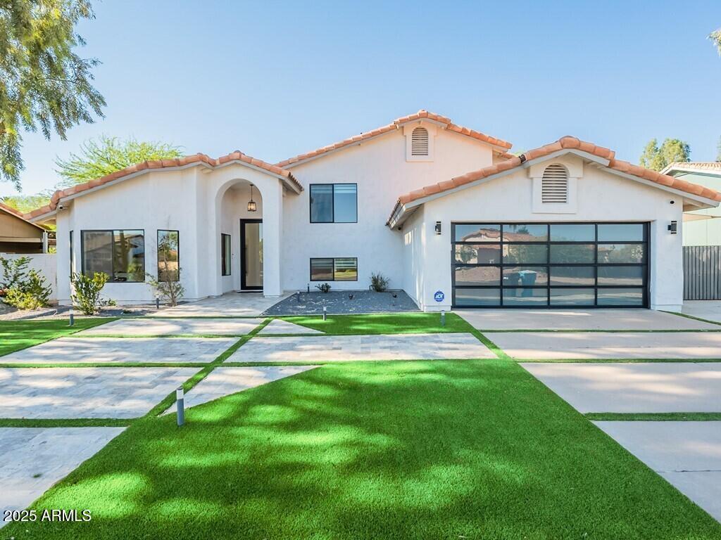 a front view of a house with a yard and garage