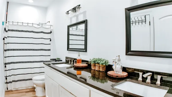 a bedroom with a bed and a potted plant