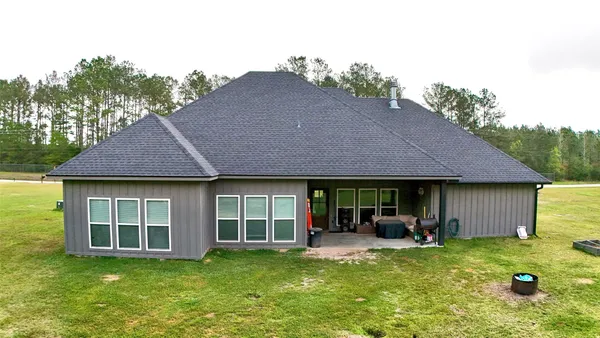 a view of a house with backyard porch and sitting area