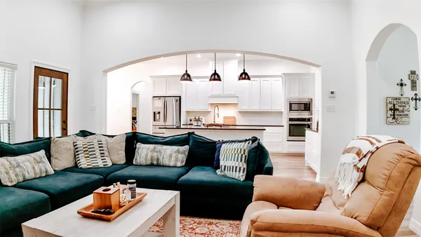 a view of living room with furniture and potted plant
