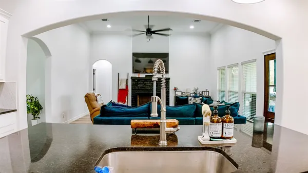 a kitchen with stainless steel appliances granite countertop a sink a stove and a refrigerator