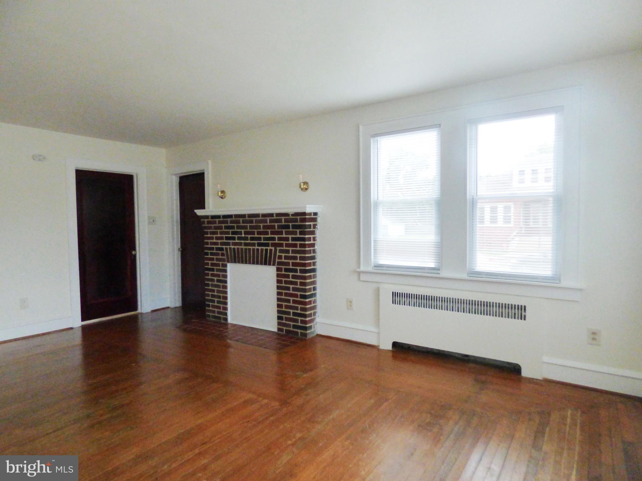 90 State Street, Unit 1 Penns Grove, NJ 08069 - Photo 13 of 21 an empty room with wooden floor and windows