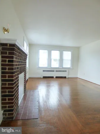 a view of room with wooden floor and window