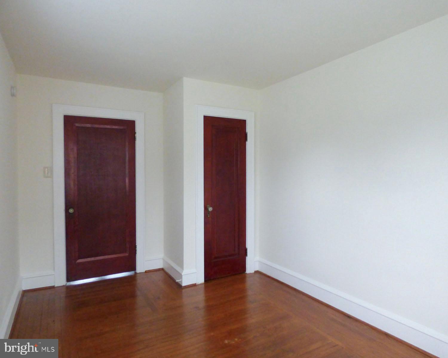 90 State Street, Unit 1 Penns Grove, NJ 08069 - Photo 16 of 21 an empty room with wooden floor and closet