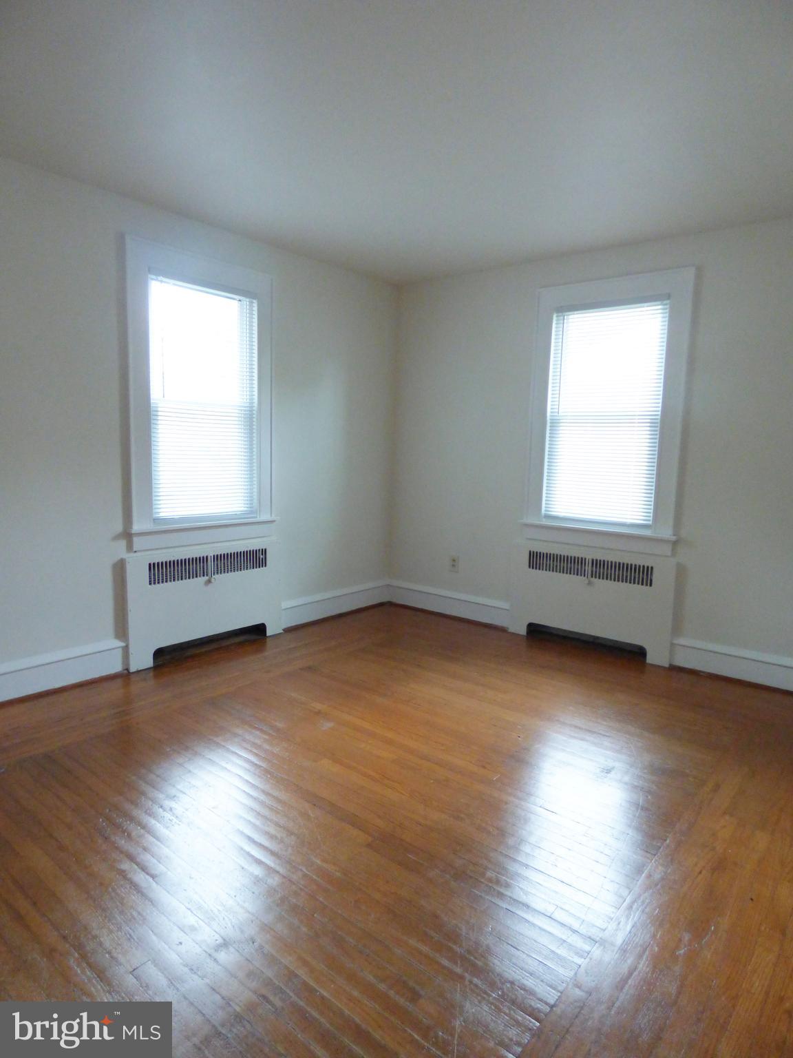 90 State Street, Unit 1 Penns Grove, NJ 08069 - Photo 17 of 21 an empty room with wooden floor and windows