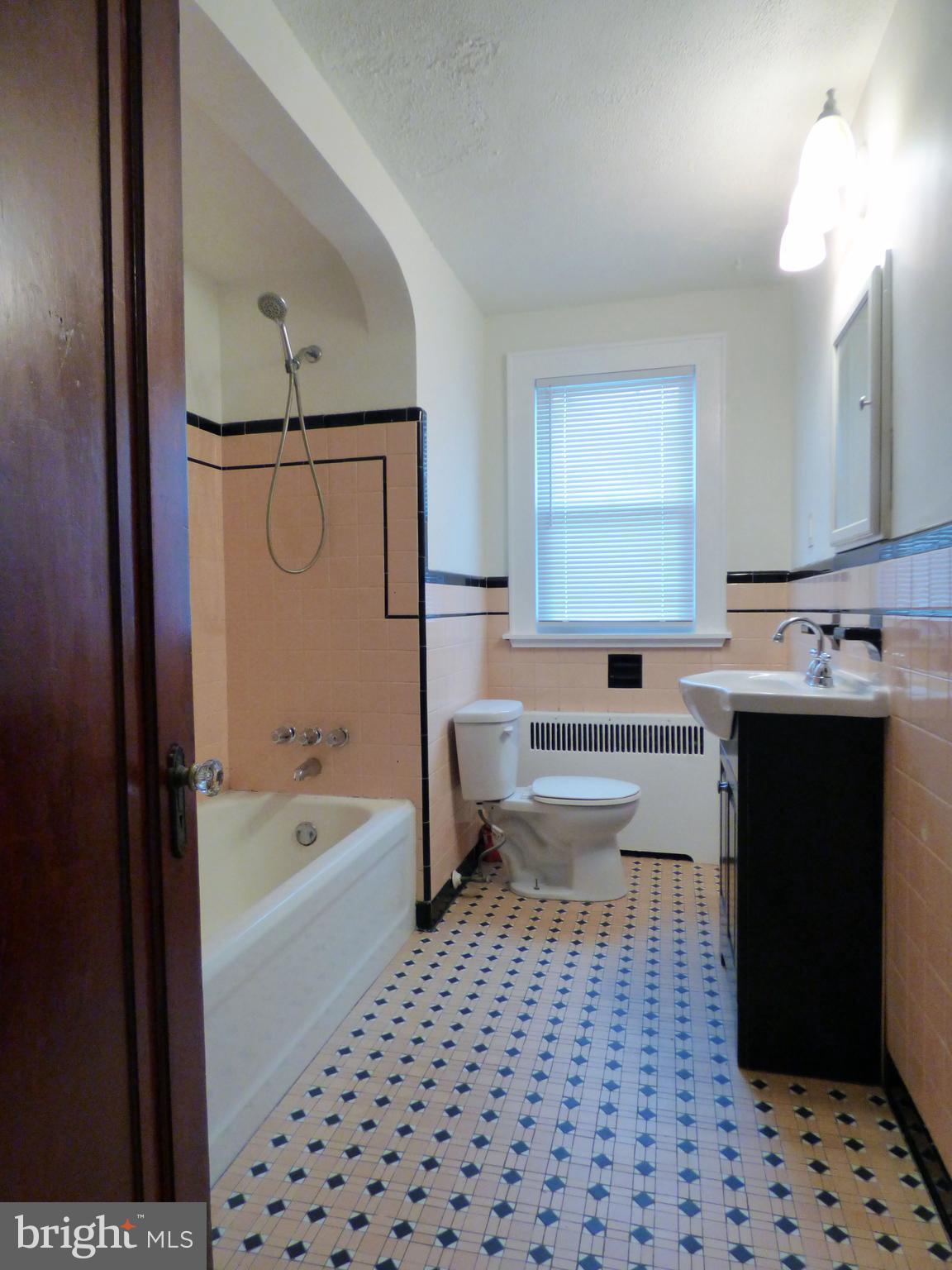 90 State Street, Unit 1 Penns Grove, NJ 08069 - Photo 19 of 21 a bathroom with a bathtub a sink a mirror and a shower
