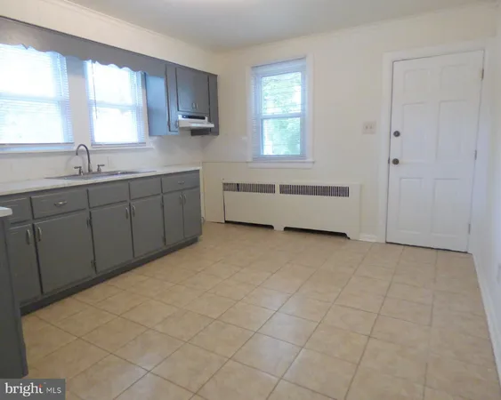 a spacious bathroom with a bathtub and a sink