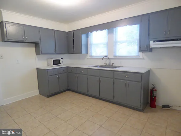 a kitchen with a sink a window and cabinets