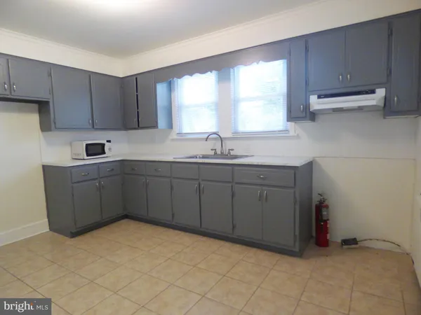 a kitchen with a sink cabinets and window