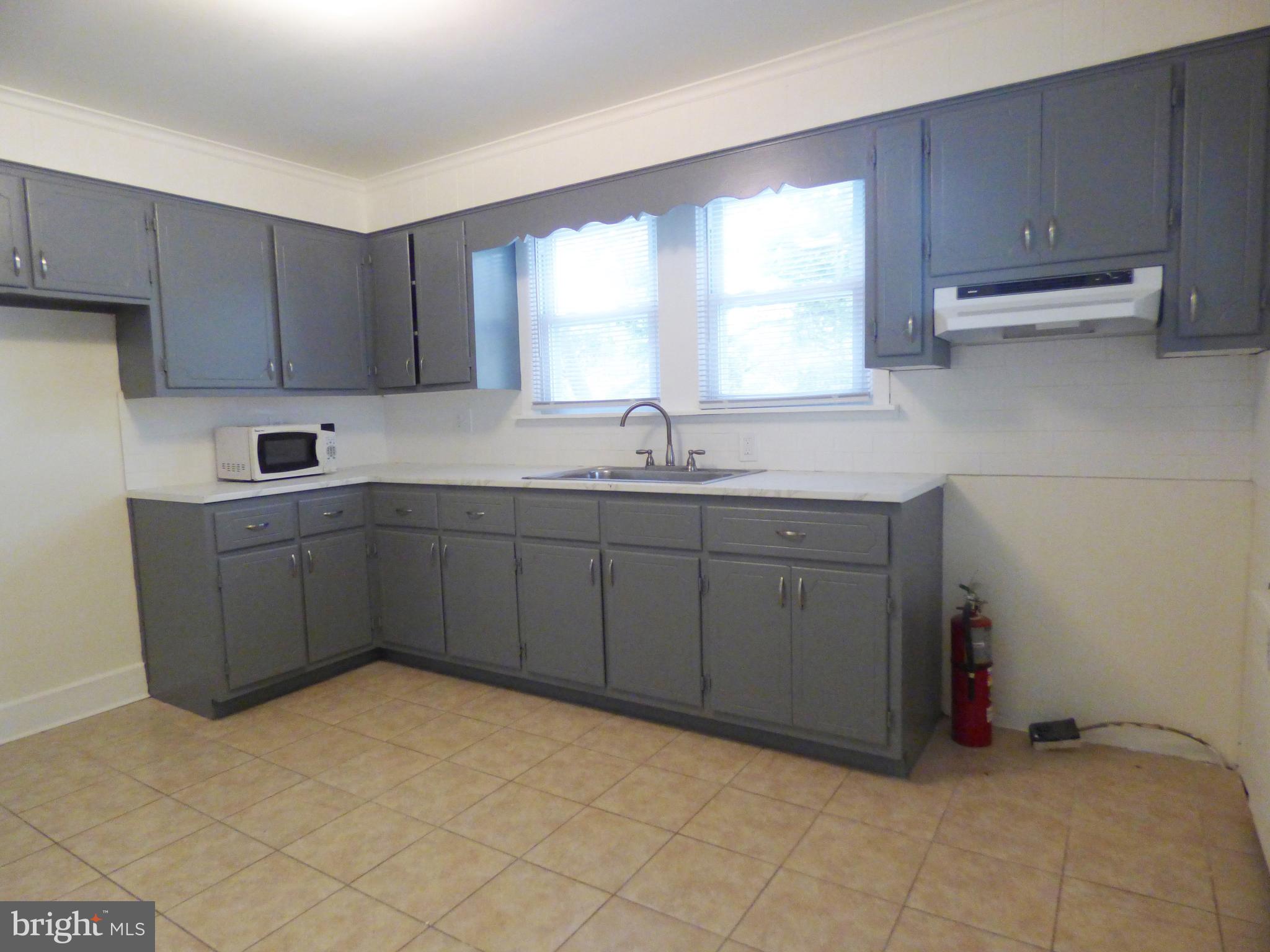 90 State Street, Unit 1 Penns Grove, NJ 08069 - Photo 6 of 21 a kitchen with a sink cabinets and window