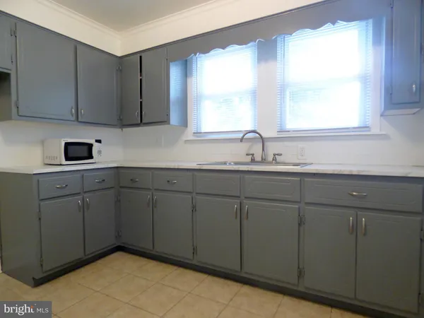 a kitchen with a sink cabinets and window