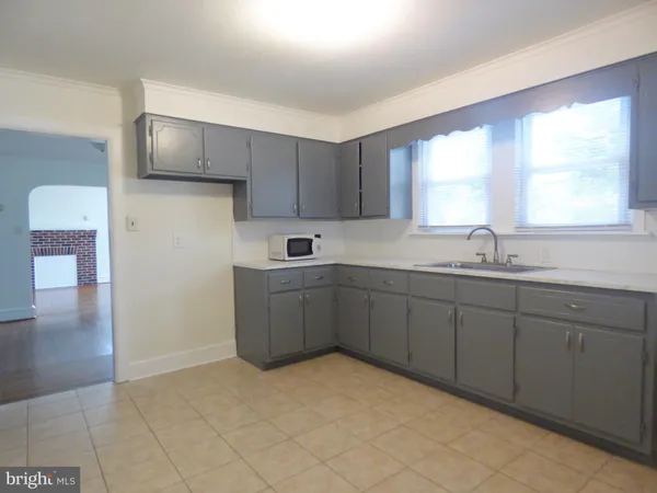 a kitchen with a sink cabinets and window