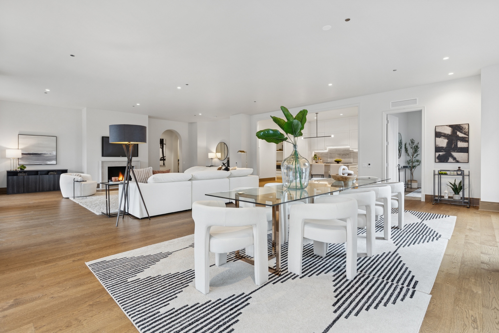 21 North May Street, Unit 402 Chicago, IL 60607 - Photo 23 of 63 a living room with furniture a wooden floor and kitchen view