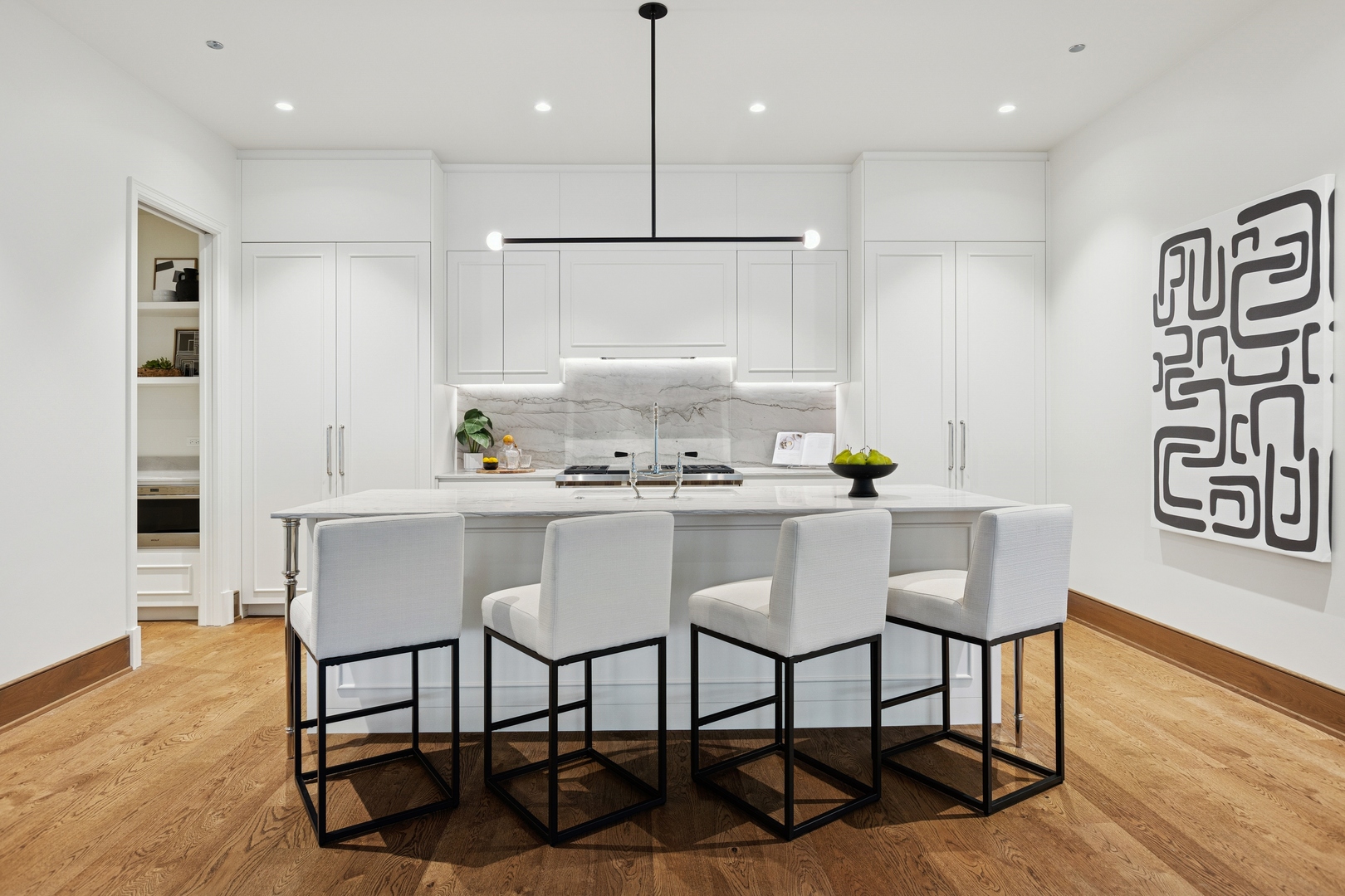 21 North May Street, Unit 402 Chicago, IL 60607 - Photo 30 of 63 a kitchen with a table chairs refrigerator and cabinets