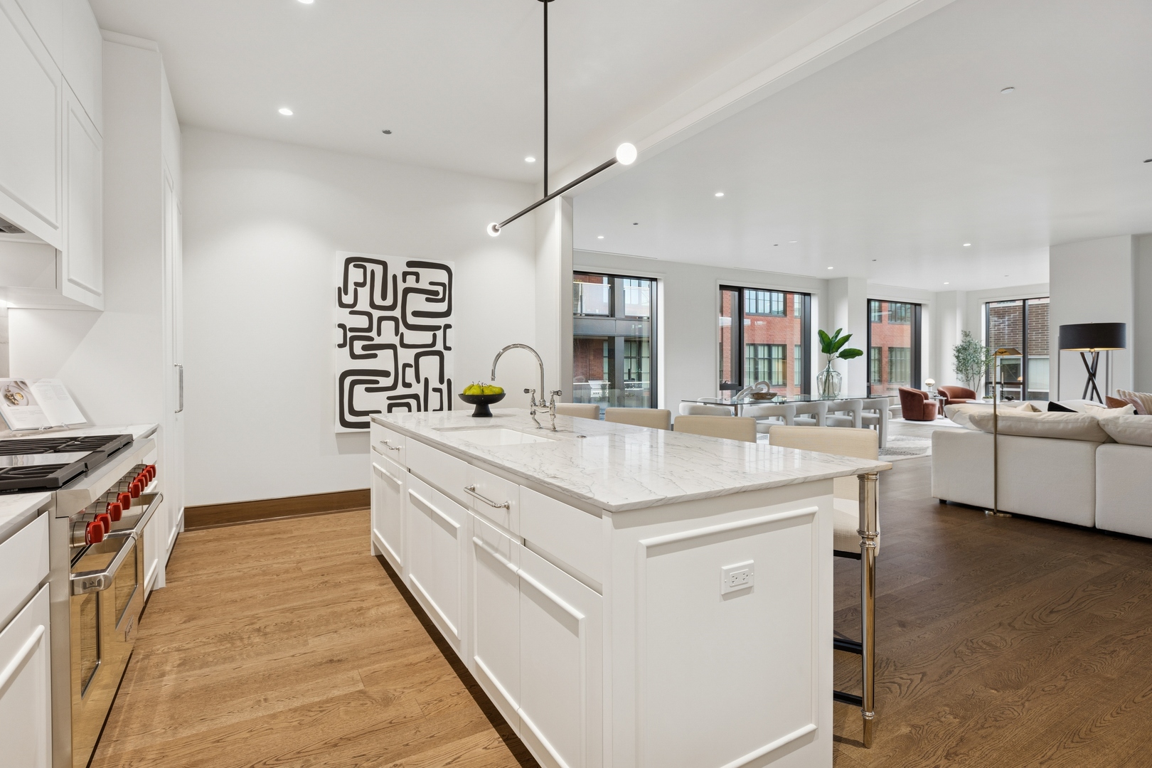 21 North May Street, Unit 402 Chicago, IL 60607 - Photo 34 of 63 a large white kitchen with stainless steel appliances granite countertop a stove and a sink