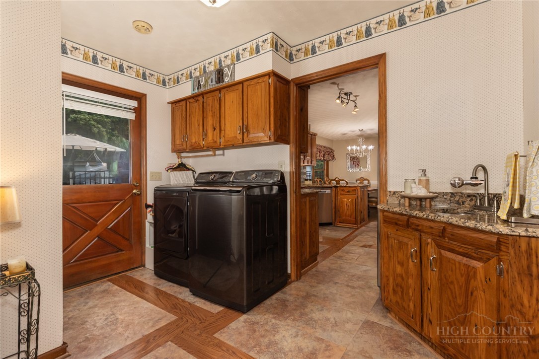 1335 Shingle Gap Road Purlear, NC 28665 - Photo 19 of 49 a kitchen with stainless steel appliances granite countertop a stove a sink dishwasher and a refrigerator