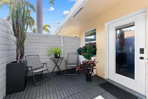 a view of a balcony with table and chairs