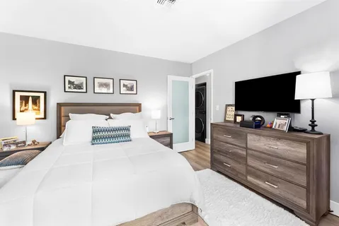 a bedroom with a bed and a flat screen tv