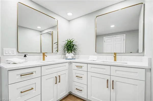 a kitchen with kitchen island granite countertop a sink and cabinets