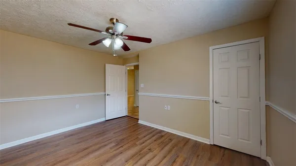 a view of an empty room and wooden floor