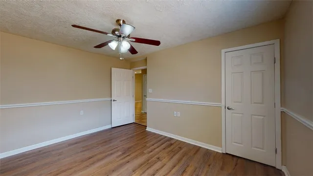 a view of an empty room and wooden floor