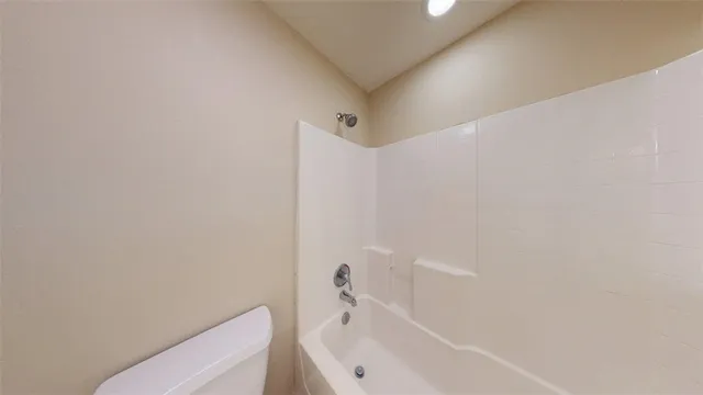 a bathroom with a bathtub and toilet
