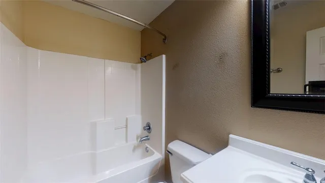 a bathroom with a bathtub and a toilet