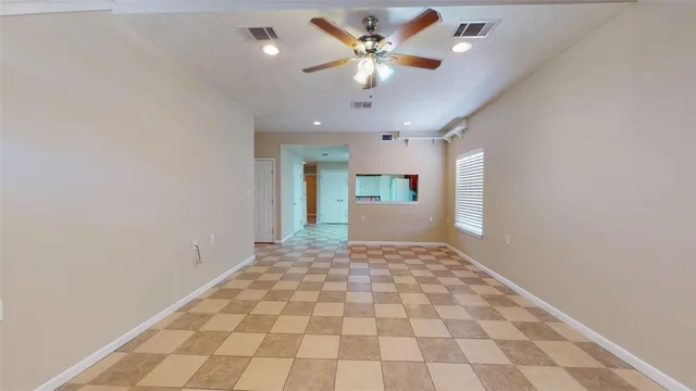 a view of a hallway with a chandelier fan and windows