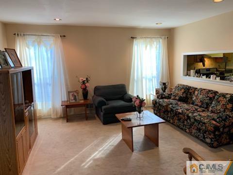 606 Maplecrest Road Edison, NJ 08820 - Photo 2 of 8 a living room with furniture and a flat screen tv