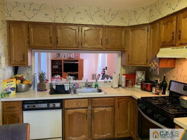 606 Maplecrest Road Edison, NJ 08820 - Photo 4 of 8 a kitchen with stainless steel appliances wooden cabinets and a stove top oven