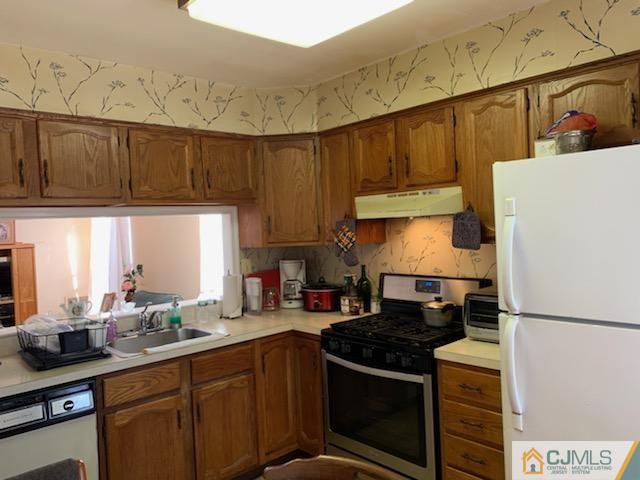 606 Maplecrest Road Edison, NJ 08820 - Photo 5 of 8 a kitchen with a sink a stove and a refrigerator