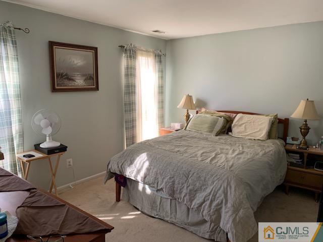 606 Maplecrest Road Edison, NJ 08820 - Photo 6 of 8 a bedroom with a bed and wooden floor