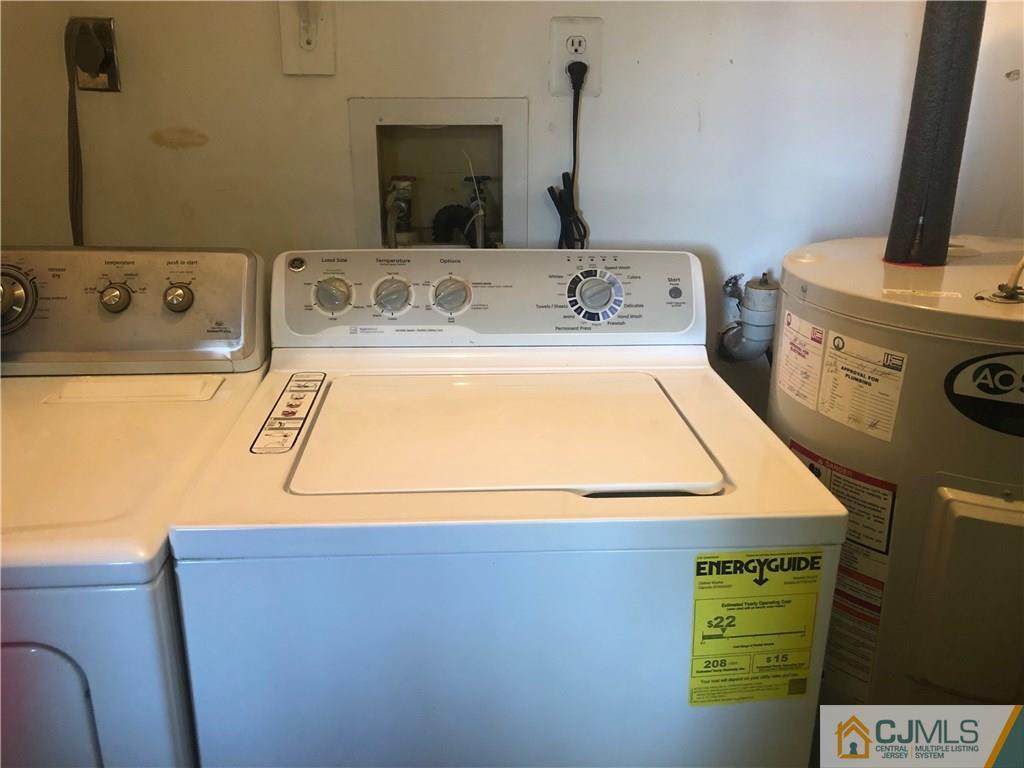 606 Maplecrest Road Edison, NJ 08820 - Photo 7 of 8 a room with a washing machine and a sink
