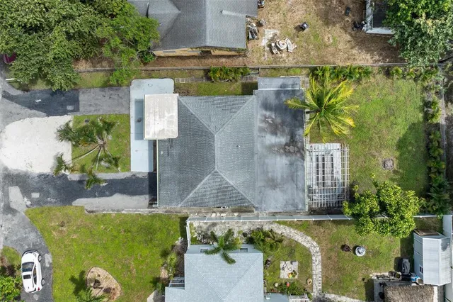 an aerial view of a house with a yard