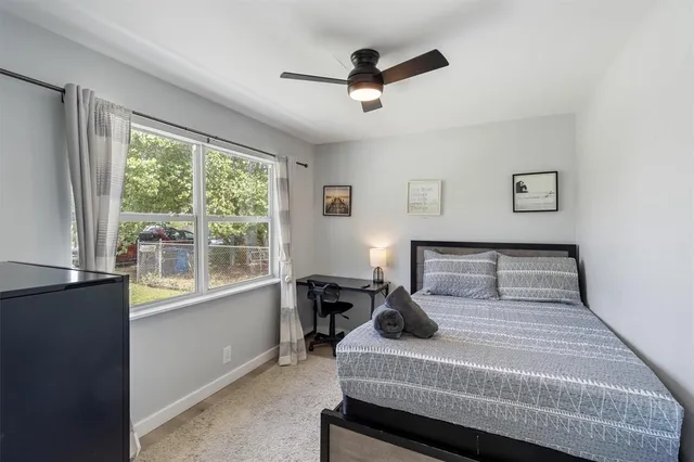 a bedroom with a large bed and a large window