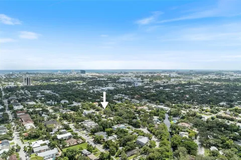 an aerial view of residential houses with city view