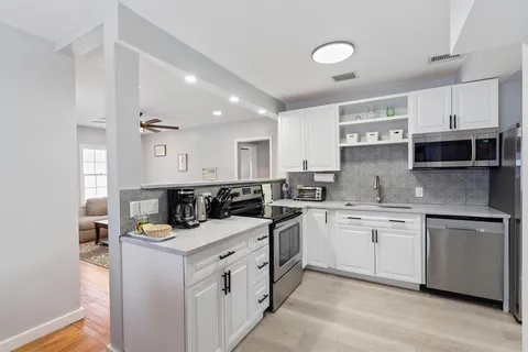 a kitchen that has a sink and a stove in it