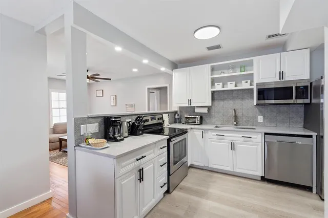 a kitchen that has a sink and a stove in it