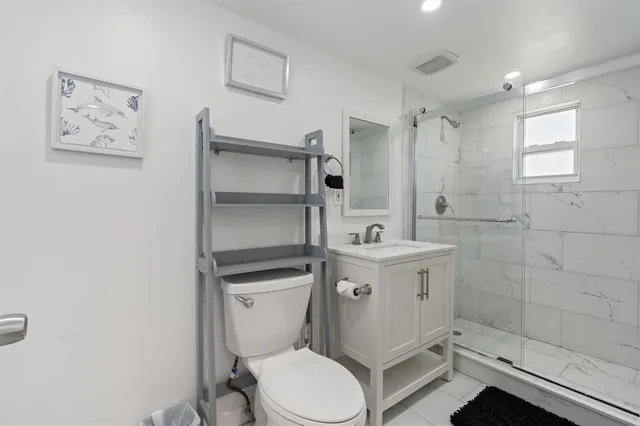 a bathroom with a toilet sink and shower