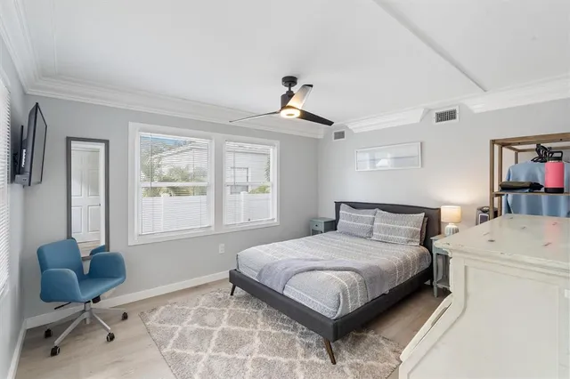 a bedroom with a bed and a chandelier