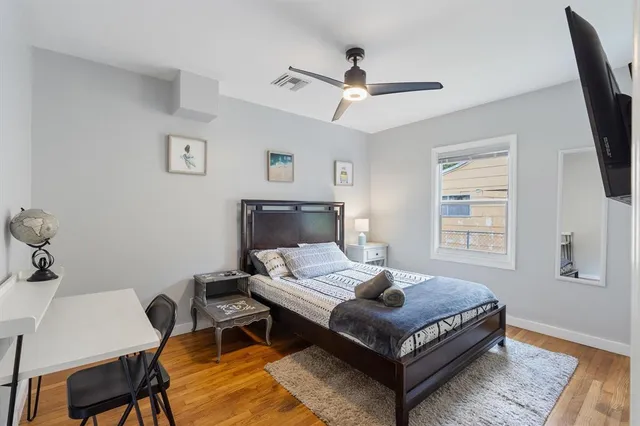 a bedroom with a bed window and a desk