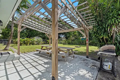 a view of a yard with furniture and garden