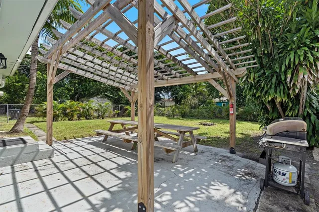 a view of a yard with furniture and garden
