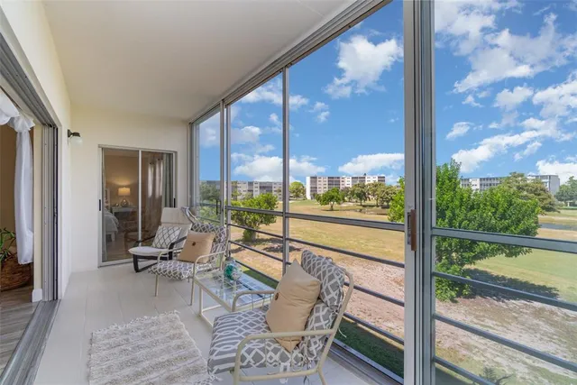 a living room with couch and a floor to ceiling window