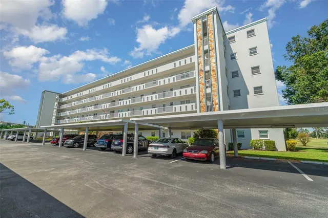 a view of a building with car parked