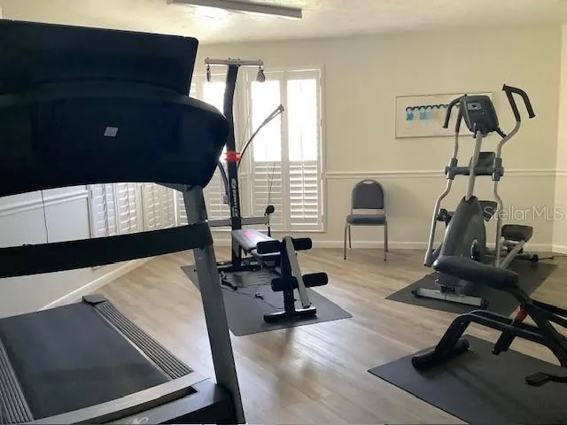 a view of workspace with wooden floor windows