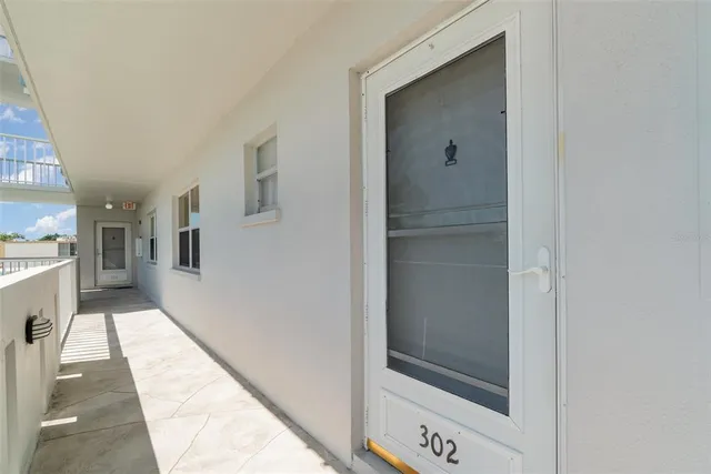 a hallway with a large mirror and shower