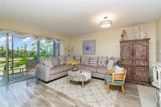 a living room with furniture and a floor to ceiling window